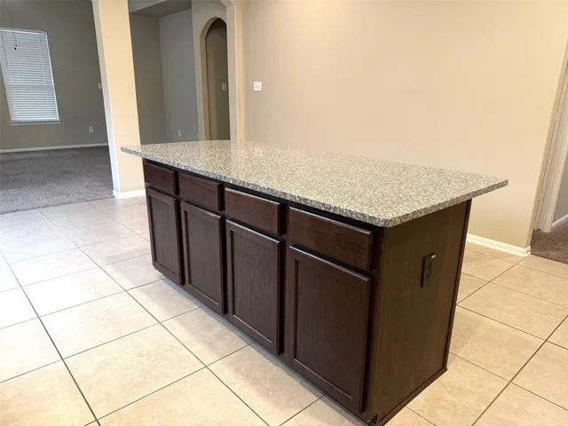a kitchen with a sink a counter top space and cabinets