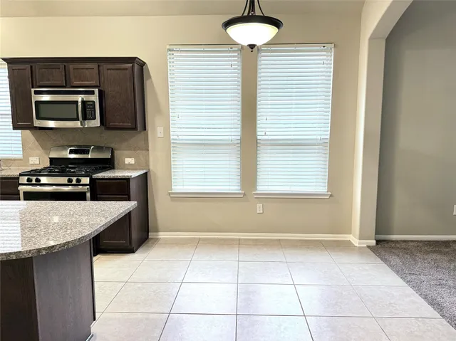 a kitchen with a stove a sink and a microwave