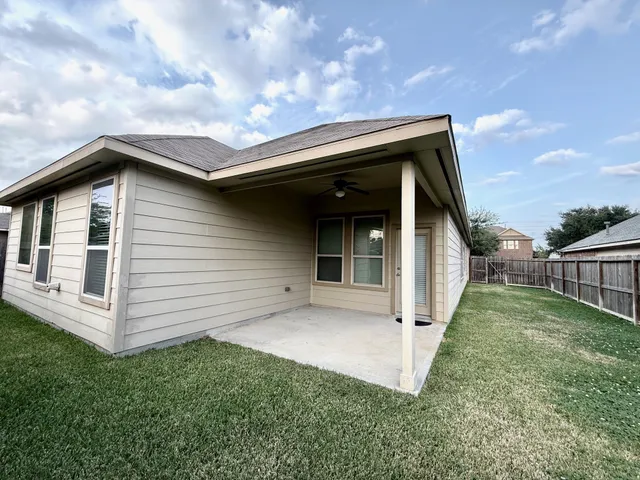 a view of house with backyard