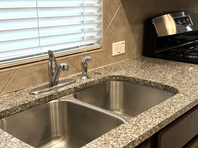 a view of a kitchen counter top a sink and dishwasher