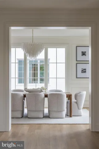 a view of a dining room with furniture large windows and wooden floor