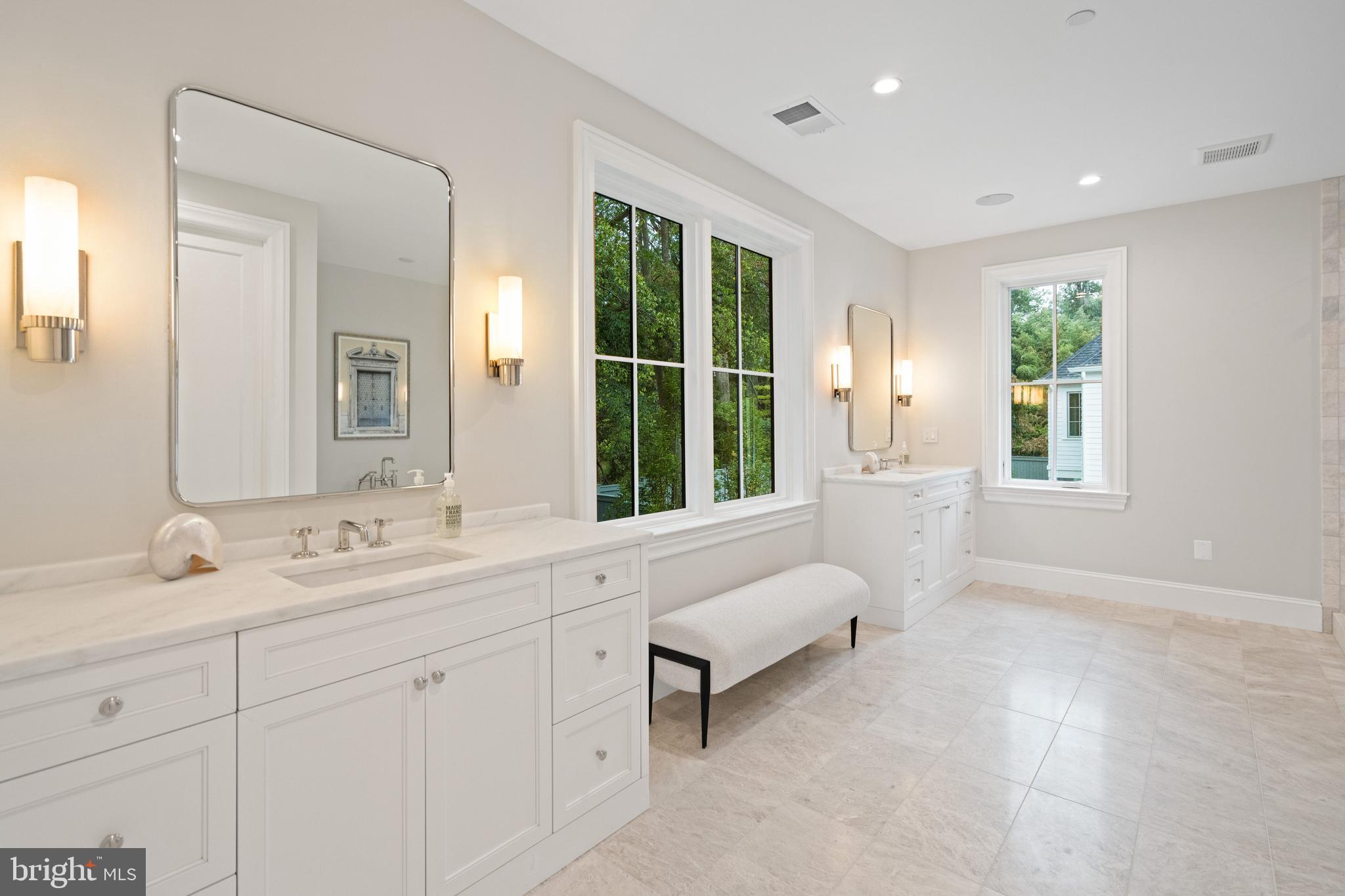2916 Chesapeake Street Northwest Washington, DC 20008 - Photo 24 of 54 a spacious bathroom with a double vanity sink a mirror and a bathtub