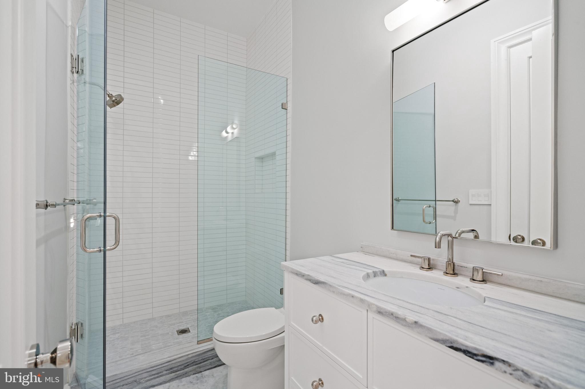 2916 Chesapeake Street Northwest Washington, DC 20008 - Photo 46 of 54 a bathroom with a granite countertop sink toilet and shower