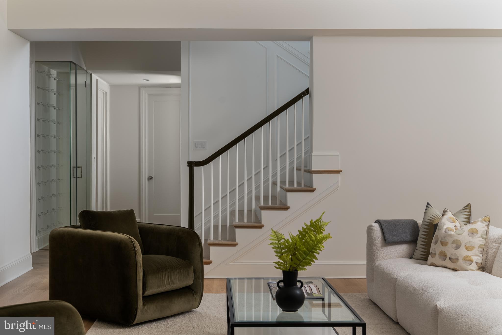 2916 Chesapeake Street Northwest Washington, DC 20008 - Photo 47 of 62 a living room with furniture staircase and a potted plant