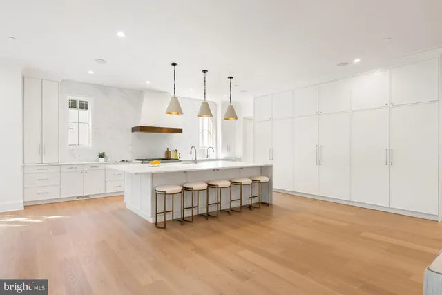 a living room with a large window and dining table