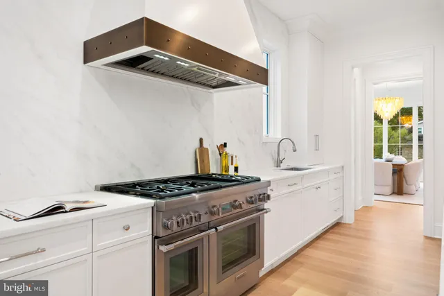 a living room with a large window and dining table