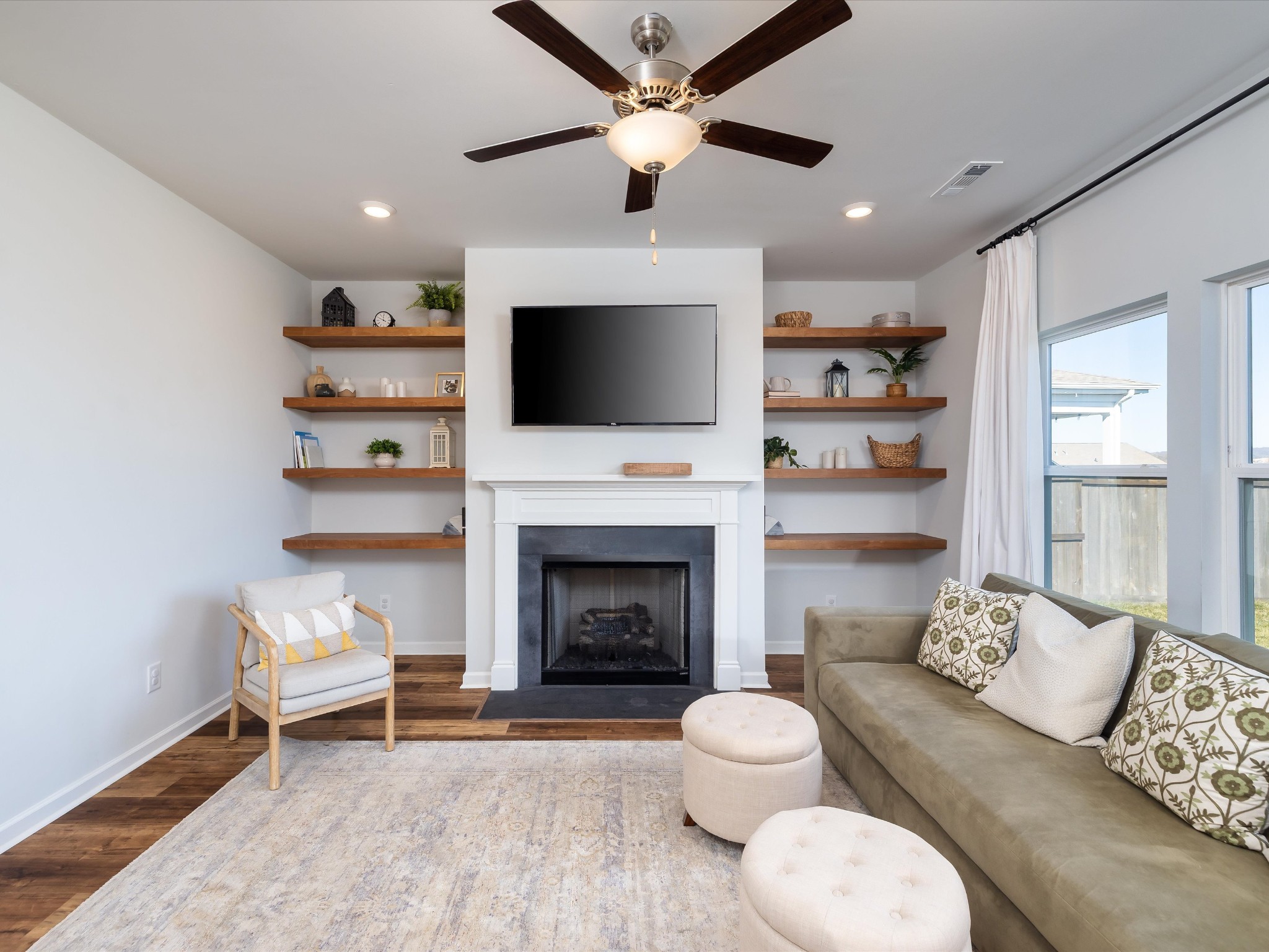 409 Rangeland Road Spring Hill, TN 37174 - Photo 11 of 75 a living room with furniture a fireplace and a flat screen tv