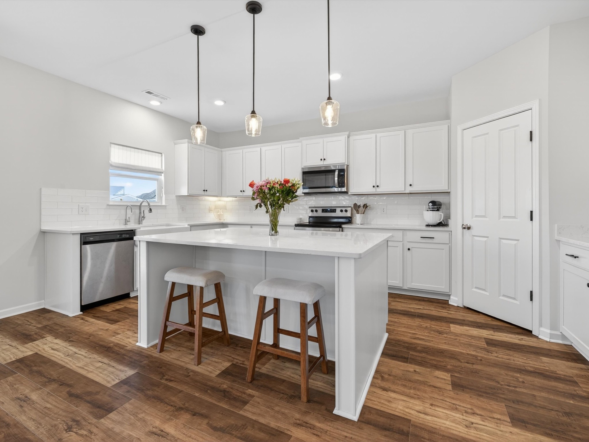 409 Rangeland Road Spring Hill, TN 37174 - Photo 15 of 75 a kitchen with kitchen island granite countertop a sink a counter space appliances and cabinets