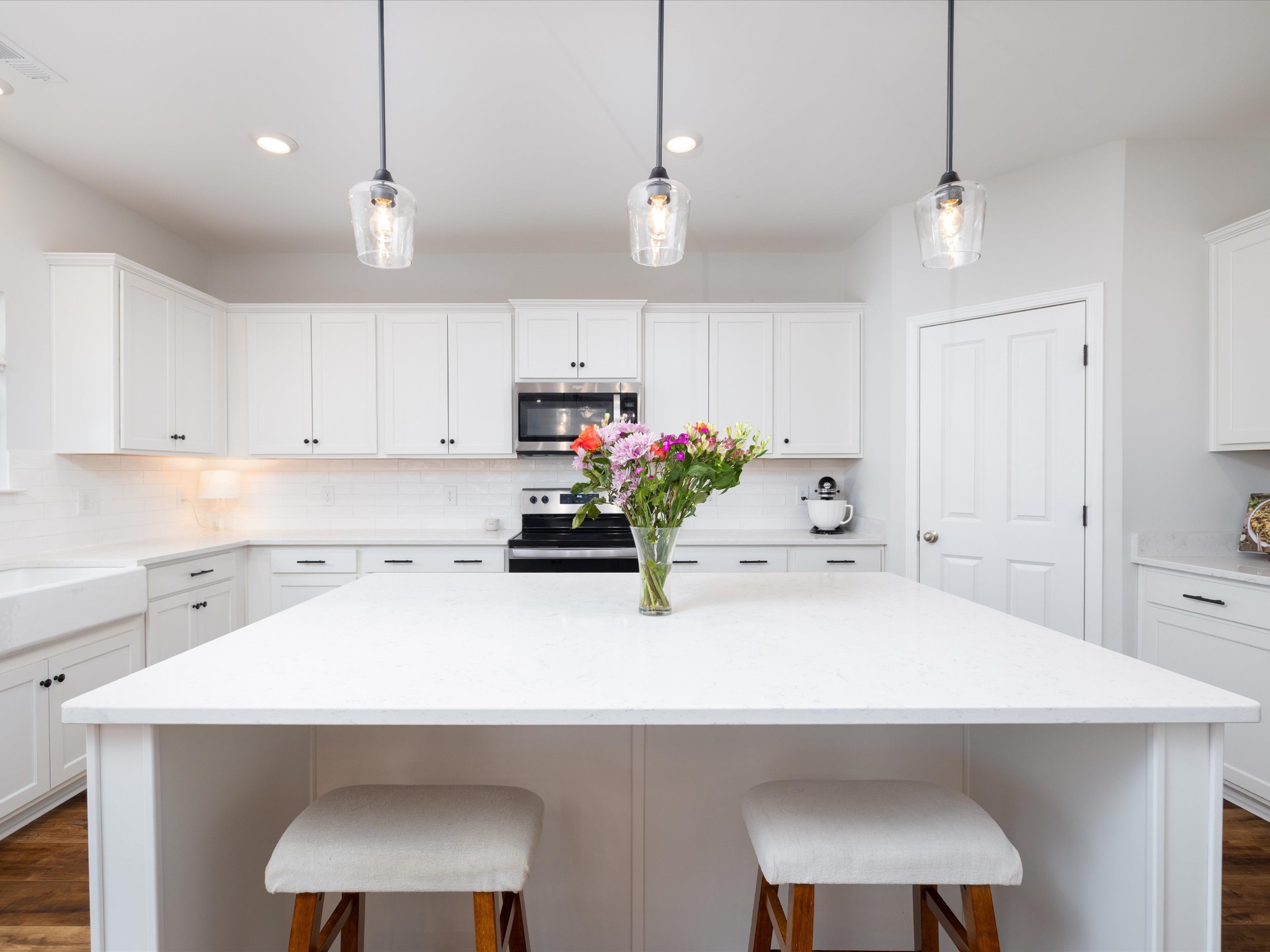 409 Rangeland Road Spring Hill, TN 37174 - Photo 18 of 75 a kitchen with a sink a refrigerator and white cabinets