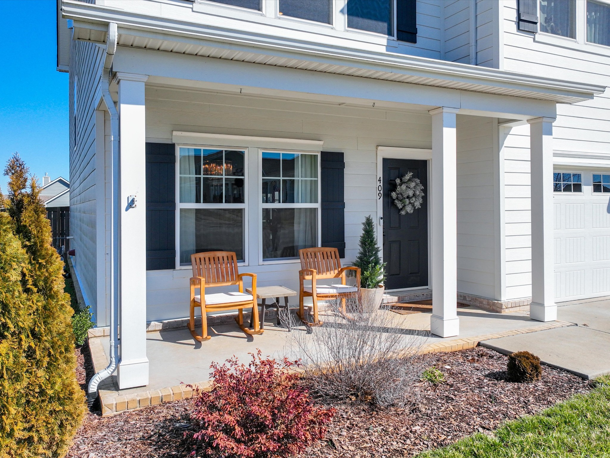 409 Rangeland Road Spring Hill, TN 37174 - Photo 2 of 75 front view of a house with a chairs and table in a patio