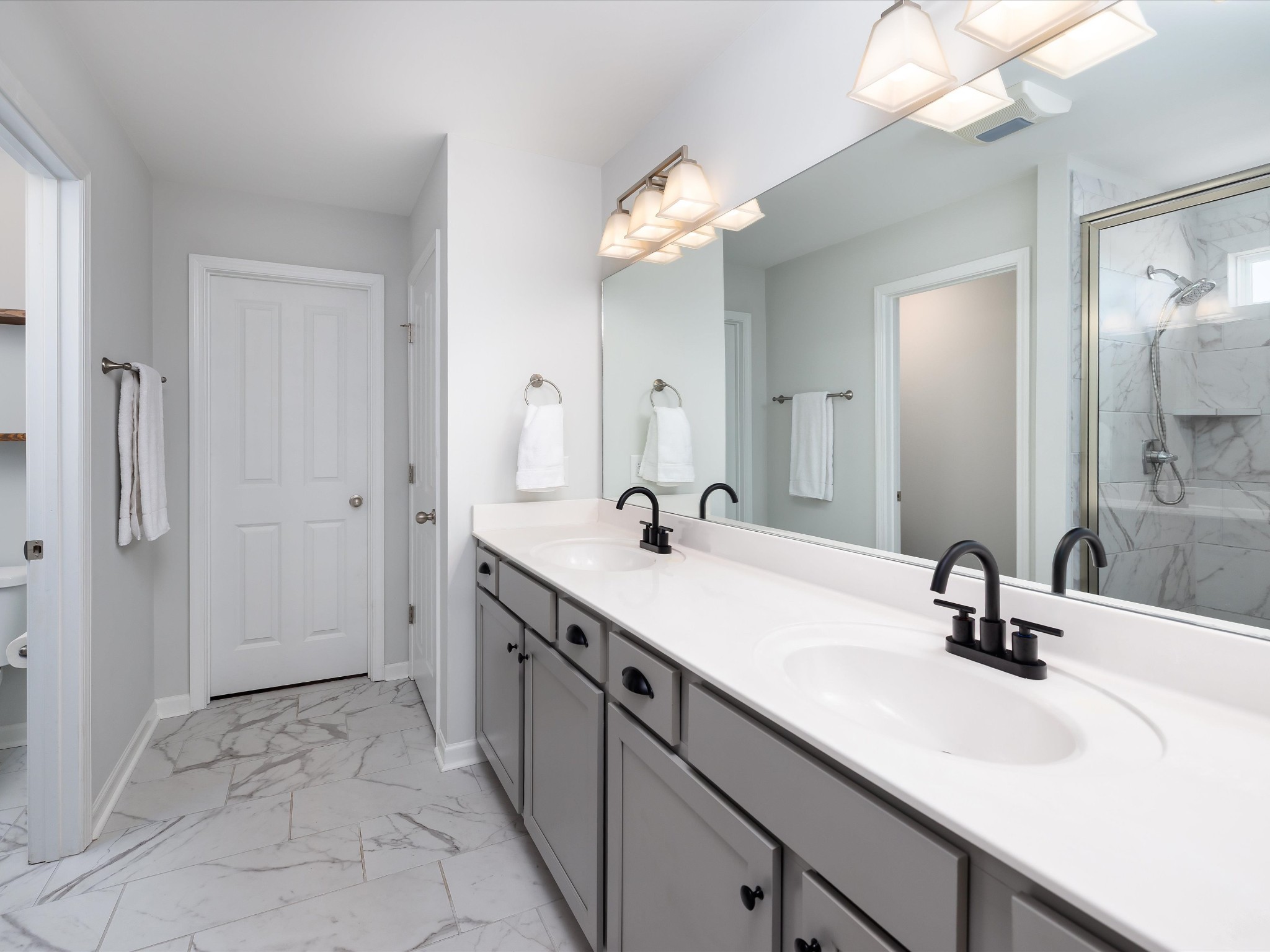 409 Rangeland Road Spring Hill, TN 37174 - Photo 36 of 75 a bathroom with a sink a light fixture and a mirror