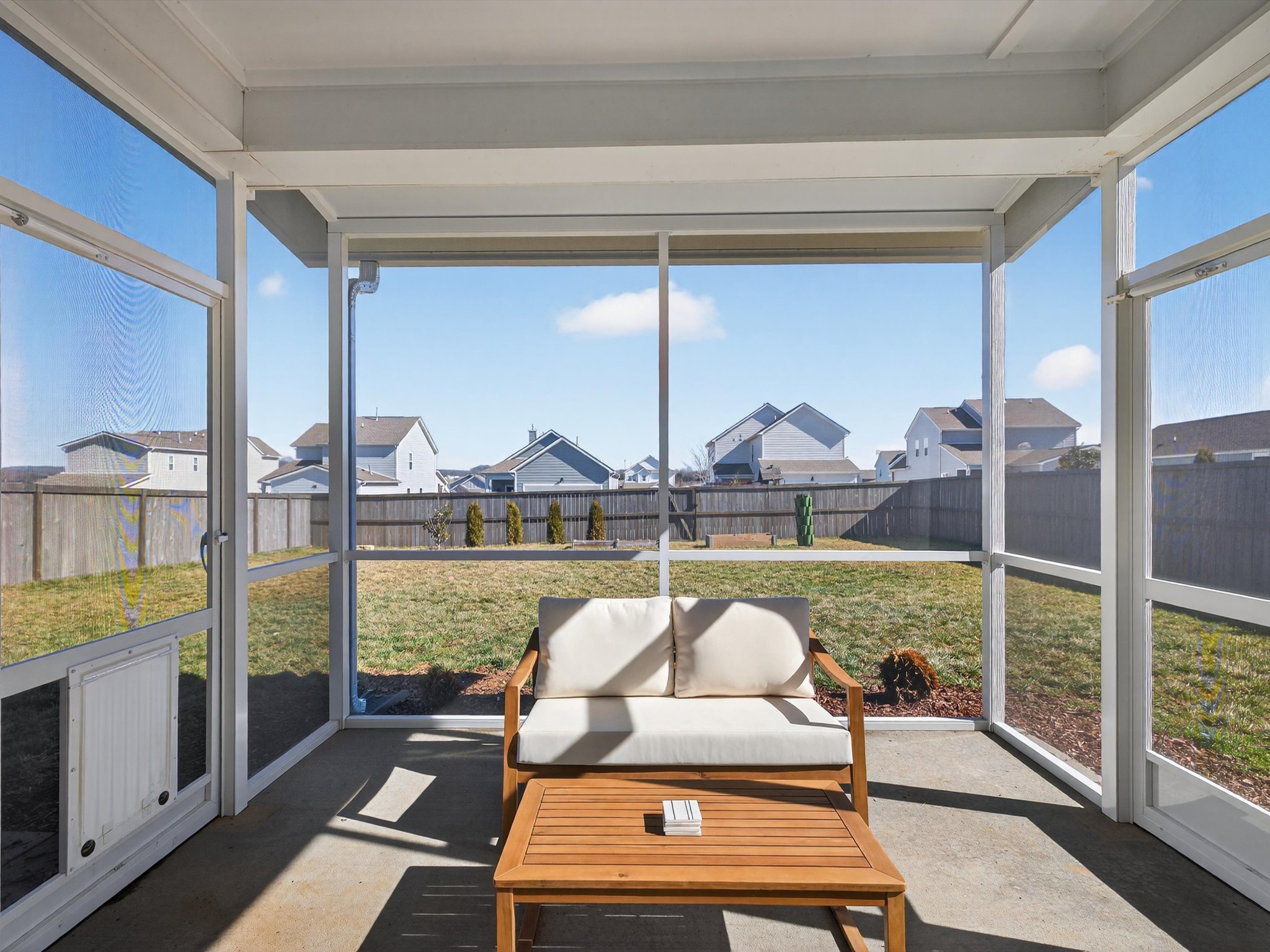 409 Rangeland Road Spring Hill, TN 37174 - Photo 53 of 75 a living room with a floor to ceiling window and a table