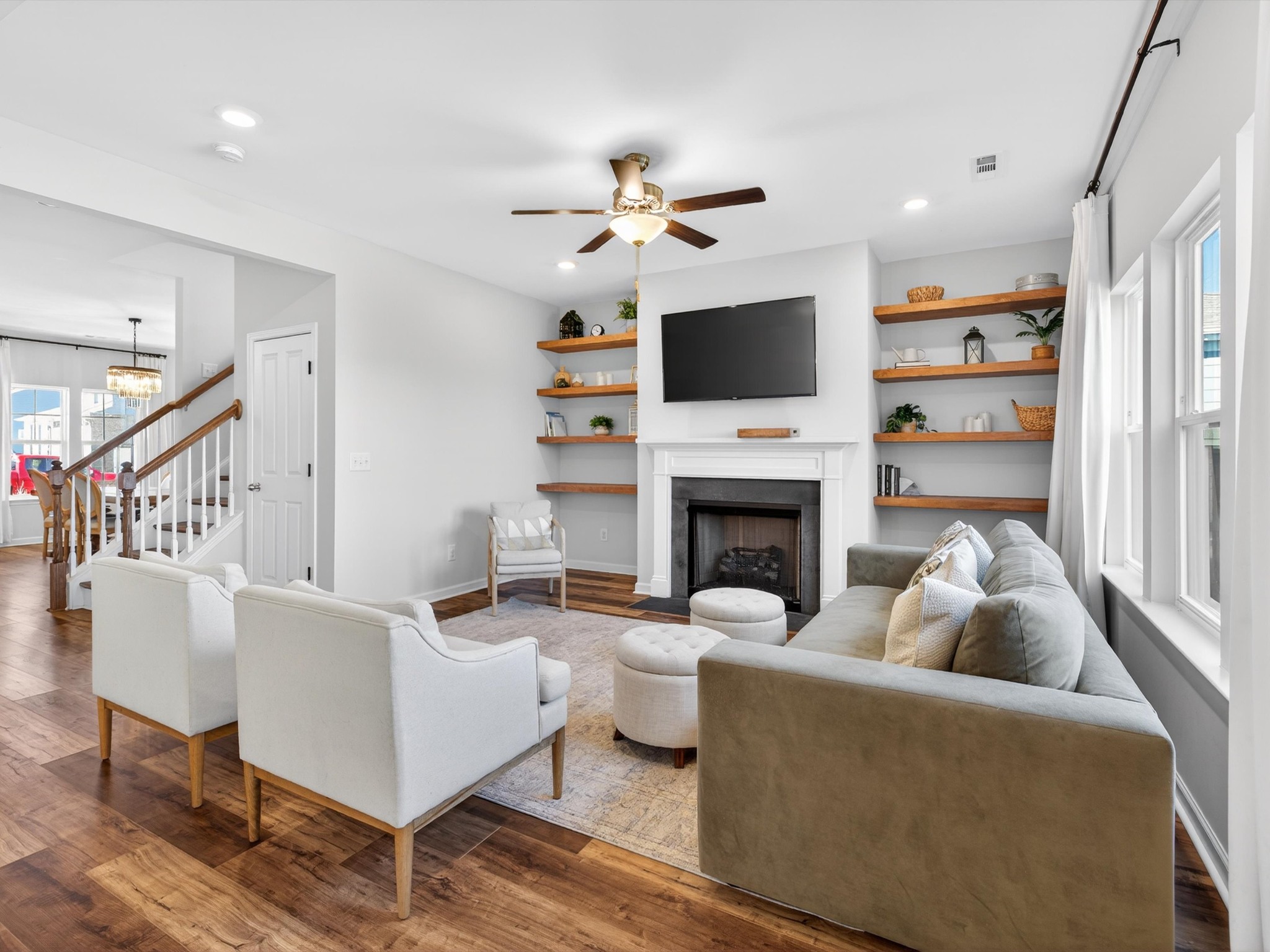 409 Rangeland Road Spring Hill, TN 37174 - Photo 8 of 75 a living room with furniture a fireplace and a flat screen tv