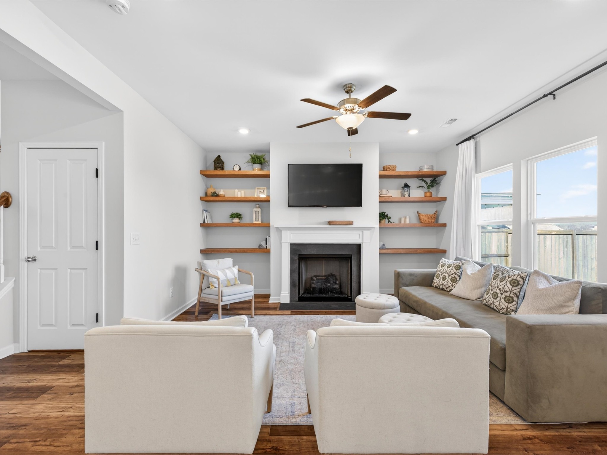 409 Rangeland Road Spring Hill, TN 37174 - Photo 10 of 75 a living room with furniture a fireplace and a flat screen tv