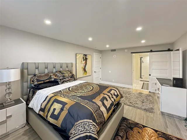 a bedroom with a large bed and a couch