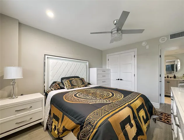 a bedroom with a bed and a lamp