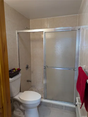a bathroom with a toilet and a shower