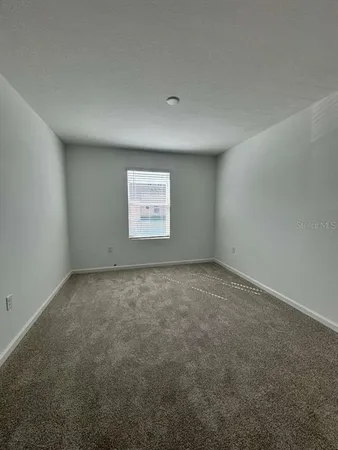 an empty room with a empty space and window