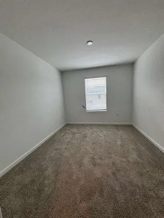 an empty room with a empty space and window
