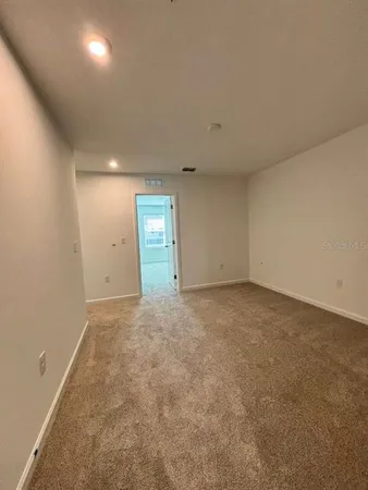 an empty room with an empty space and windows