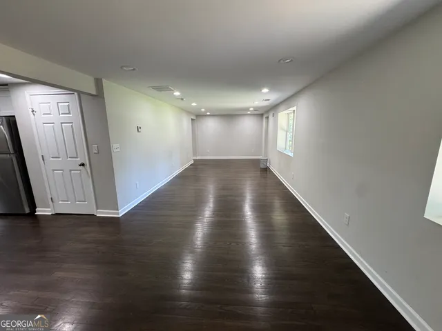 a view of gallery with wooden floor