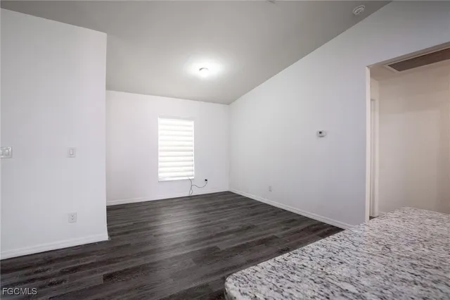 a view of a room that has wooden floor and chair in a room