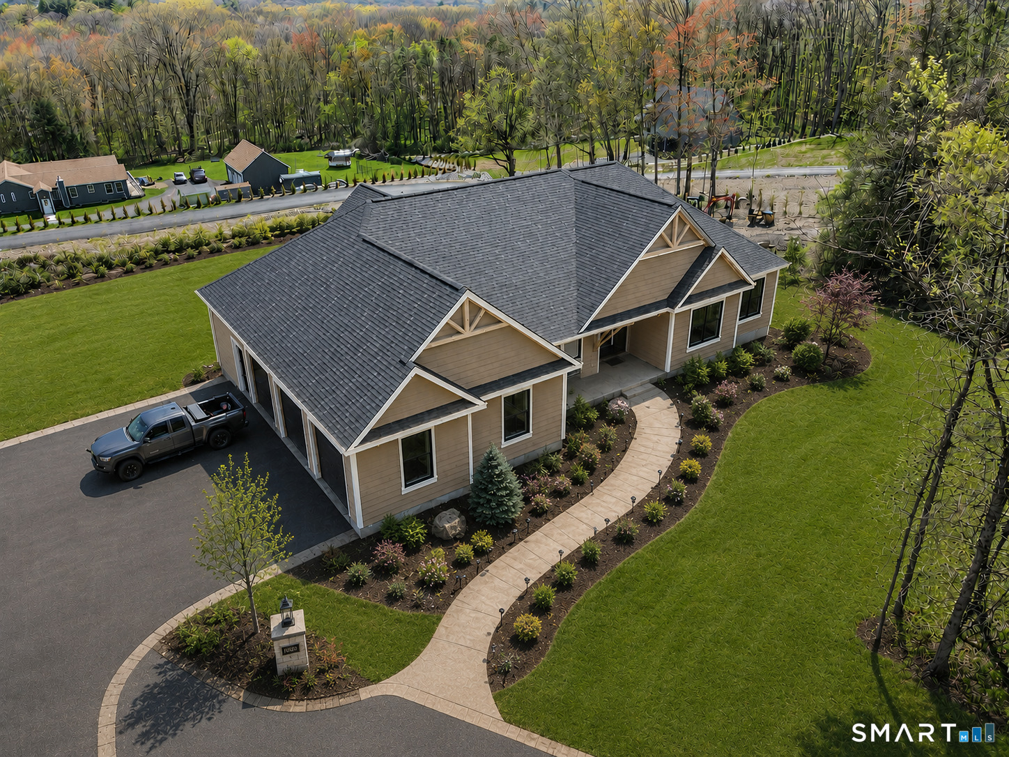 an aerial view of a house with swimming pool and lake view
