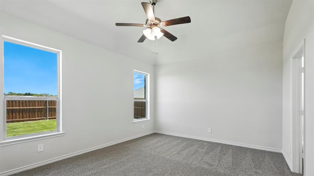 4191 Waldron Trail Forney, TX 75126 - Photo 15 of 20 Spacious room featuring vaulted ceilings, light gray carpeting, and two windows