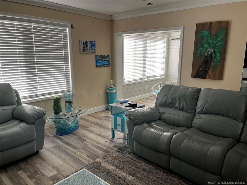 5323 Southeast Miles Grant Road, Unit 206 Stuart, FL 34997 - Photo 9 of 20 a living room with furniture and a window