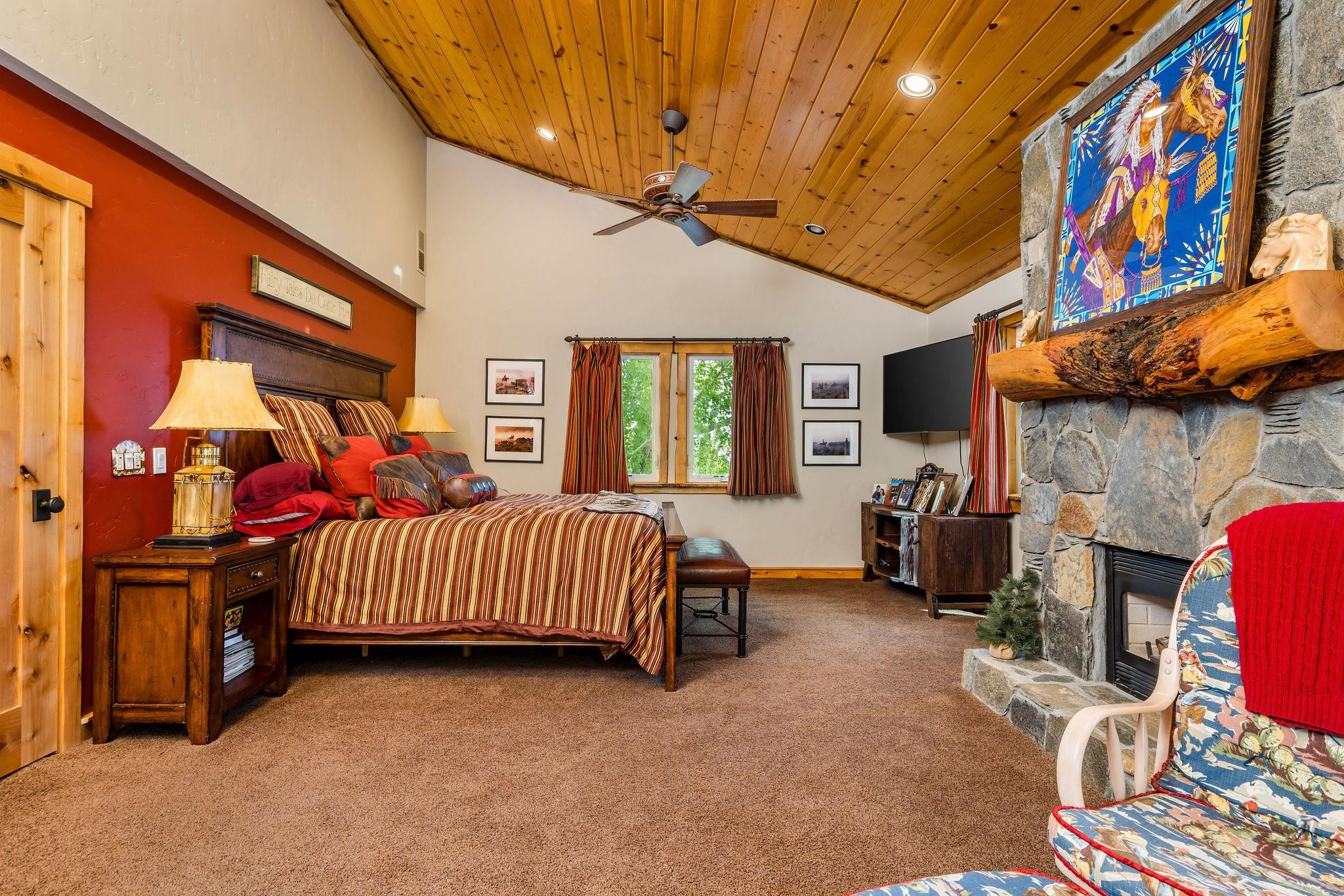 716 Aspen Springs Ranch Road, Unit 59012 Mammoth Lakes, CA 93546 - Photo 25 of 50 a bedroom with furniture and a flat screen tv