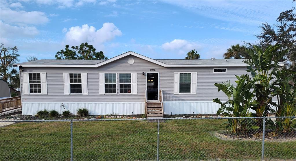 9811 Bud Street Hudson, FL 34669 - Photo 1 of 53 a front view of a house with a garden