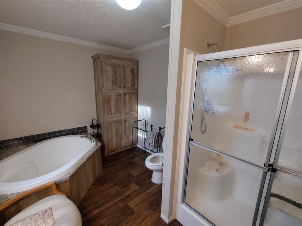 9811 Bud Street Hudson, FL 34669 - Photo 11 of 53 a bathroom with a sink and a toilet