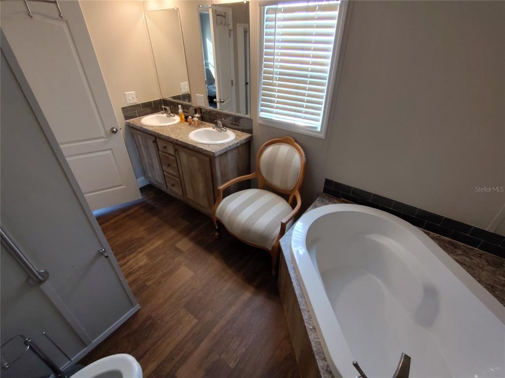 9811 Bud Street Hudson, FL 34669 - Photo 14 of 53 a bathroom with a granite countertop sink and a mirror