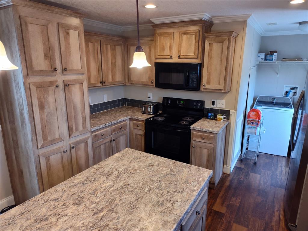 9811 Bud Street Hudson, FL 34669 - Photo 19 of 53 a kitchen with a sink stove and refrigerator