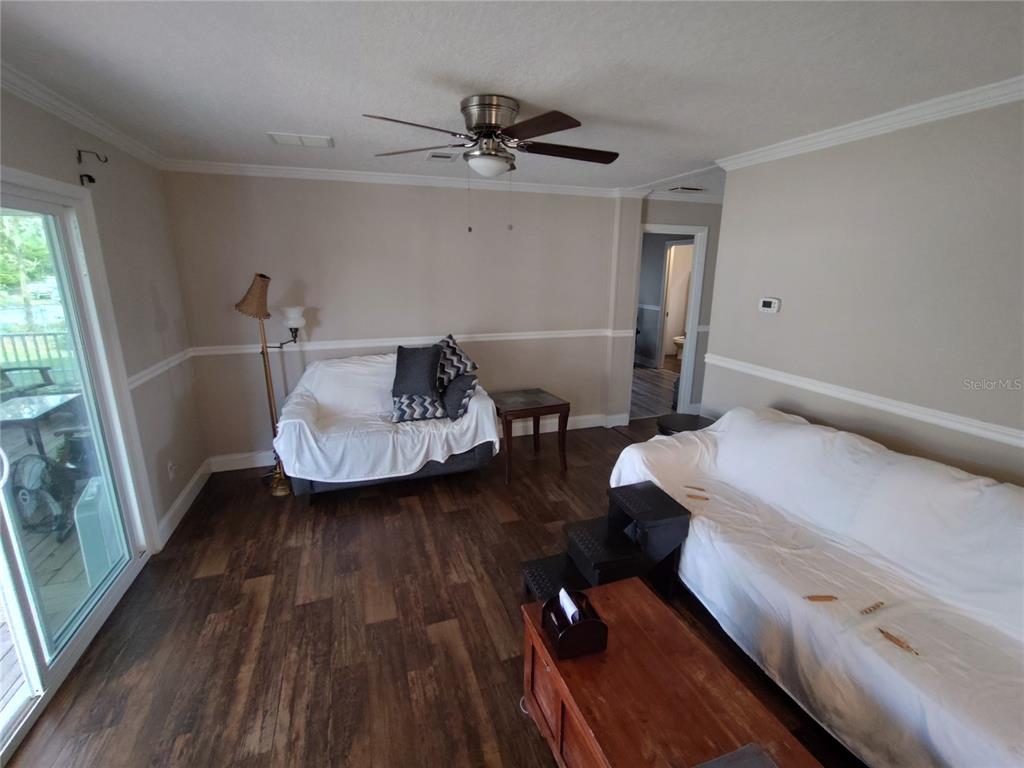 9811 Bud Street Hudson, FL 34669 - Photo 22 of 53 a living room with furniture and a wooden floor
