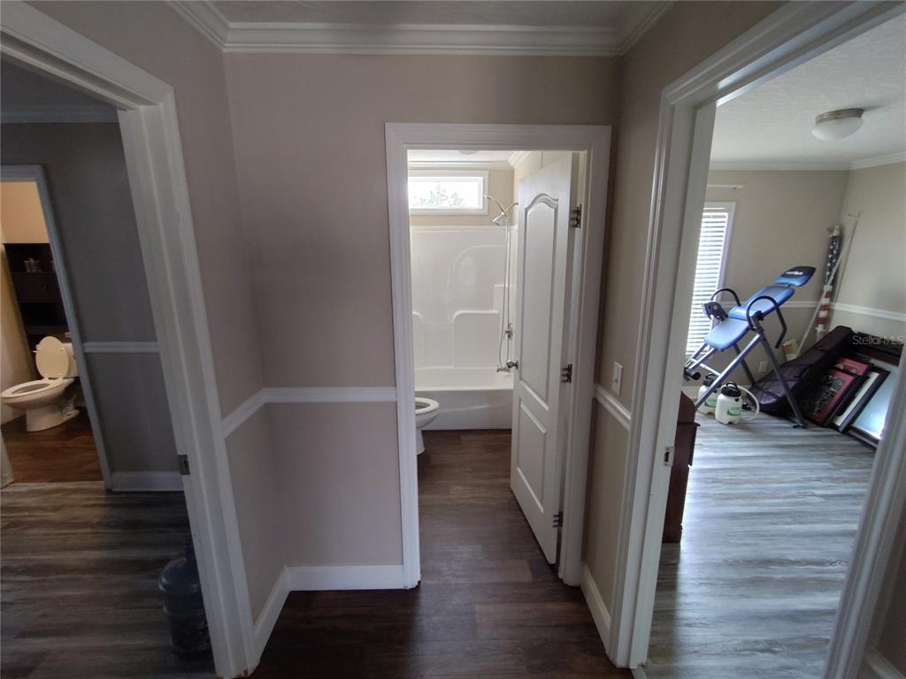 9811 Bud Street Hudson, FL 34669 - Photo 24 of 53 a view of a hallway with wooden floor and closet with wooden floor