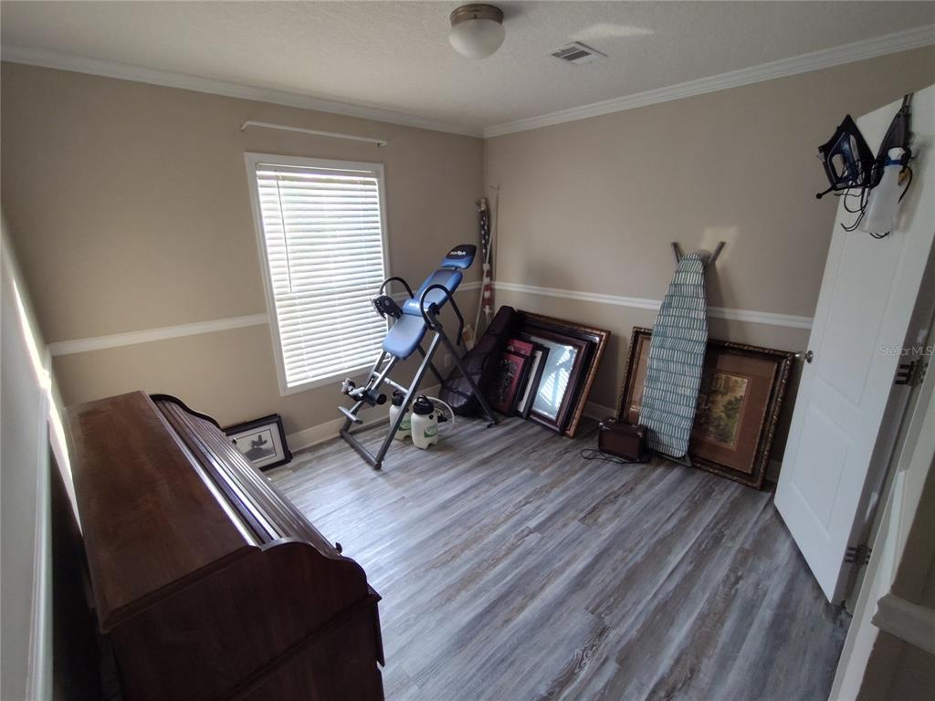 9811 Bud Street Hudson, FL 34669 - Photo 27 of 53 a view of a livingroom with furniture and a flat screen tv