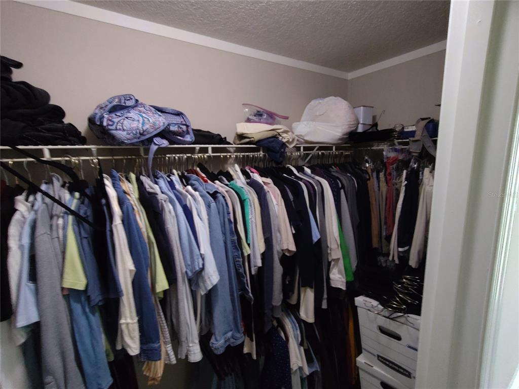 9811 Bud Street Hudson, FL 34669 - Photo 33 of 53 a view of walk in closet with clothes and shoes