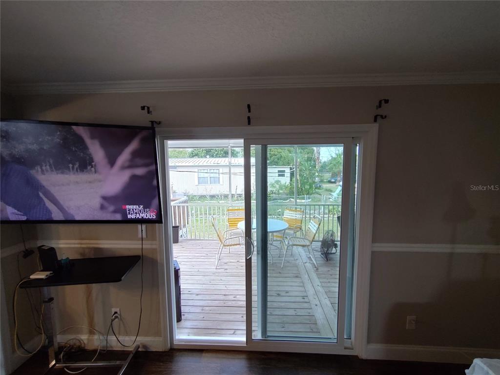 9811 Bud Street Hudson, FL 34669 - Photo 34 of 53 a view of a room with wooden floor and a fireplace