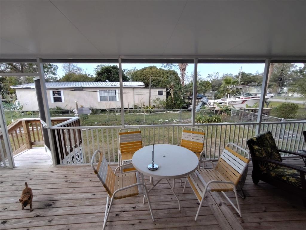 9811 Bud Street Hudson, FL 34669 - Photo 35 of 53 a view of a chairs and table in patio with a yard