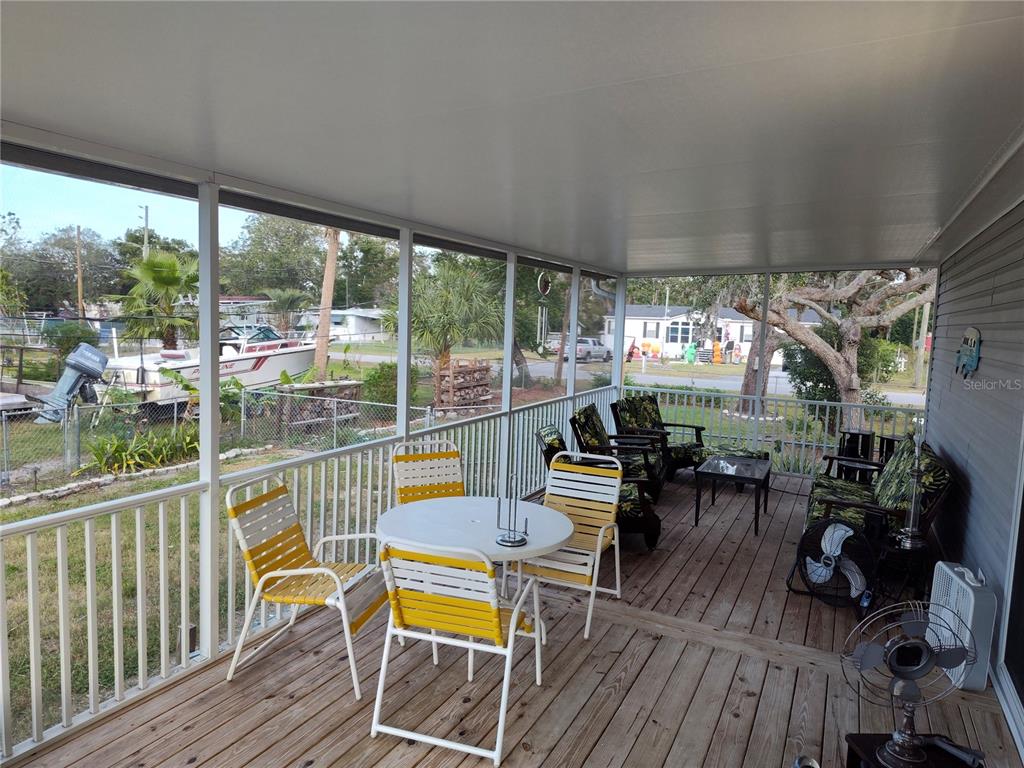 9811 Bud Street Hudson, FL 34669 - Photo 36 of 53 a view of a chairs and table in a balcony