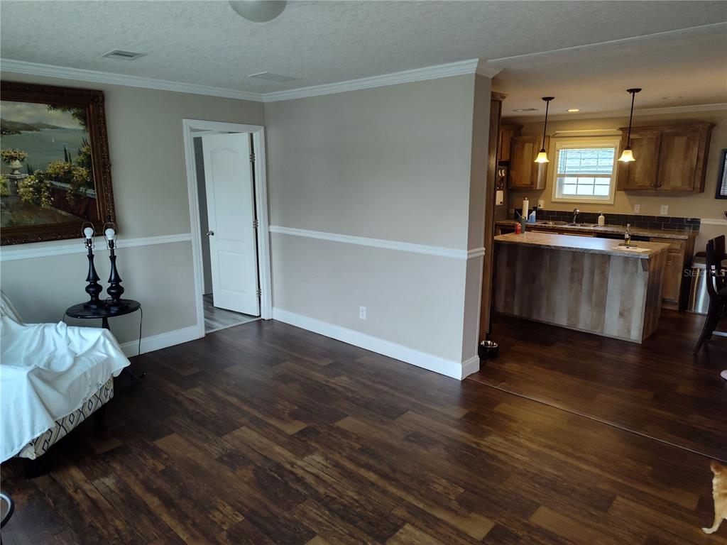 9811 Bud Street Hudson, FL 34669 - Photo 6 of 53 a view of kitchen with furniture and wooden floor