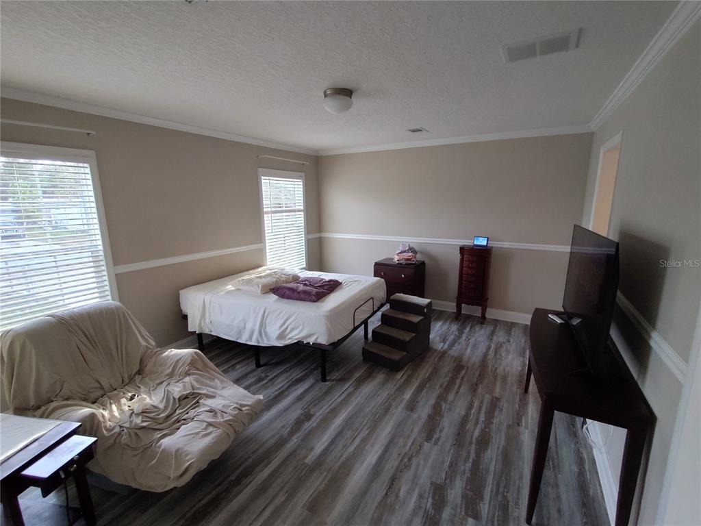 9811 Bud Street Hudson, FL 34669 - Photo 7 of 53 a living room with furniture and a flat screen tv