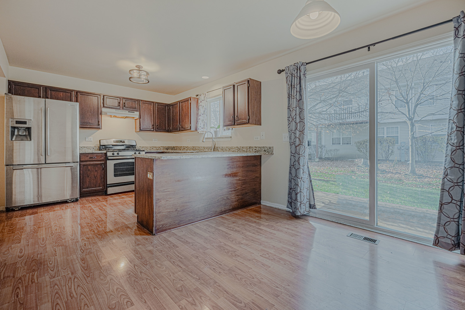 6743 Nantucket Court, Unit 6743 Gurnee, IL 60031 - Photo 11 of 30 a kitchen with stainless steel appliances granite countertop a refrigerator and a stove top oven