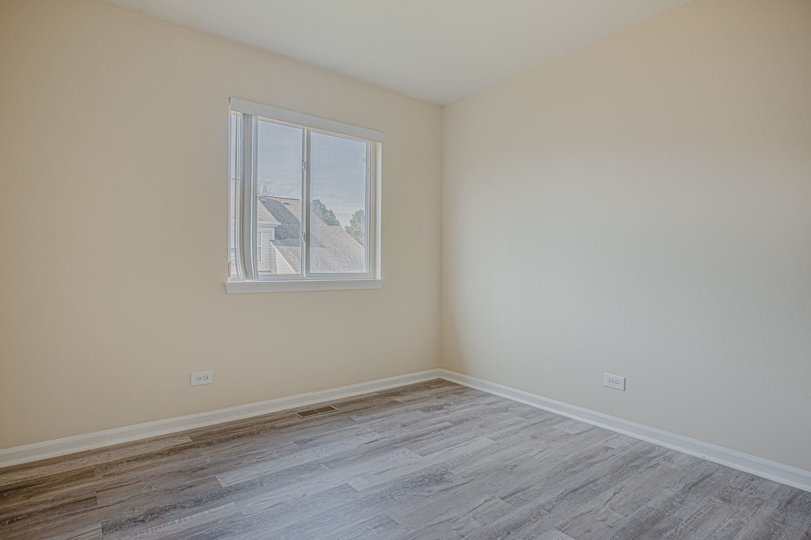 6743 Nantucket Court, Unit 6743 Gurnee, IL 60031 - Photo 14 of 30 a view of an empty room with wooden floor and a window