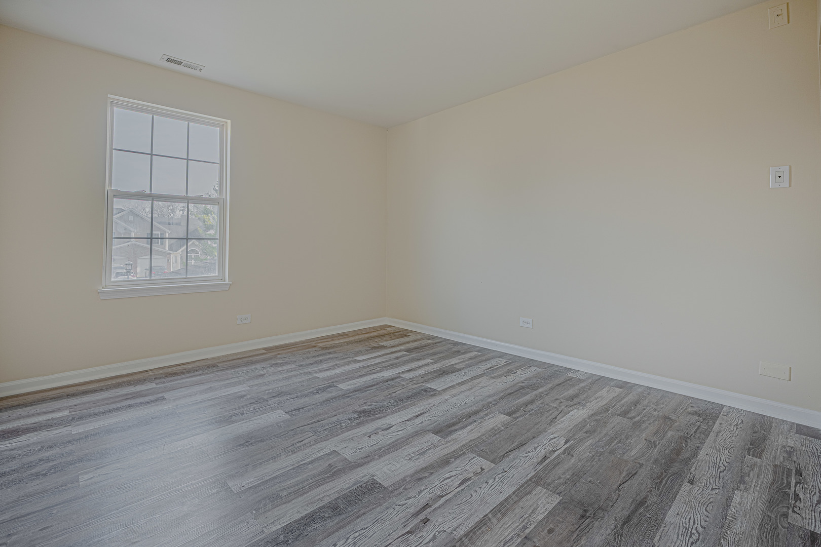 6743 Nantucket Court, Unit 6743 Gurnee, IL 60031 - Photo 16 of 30 an empty room with wooden floor and windows