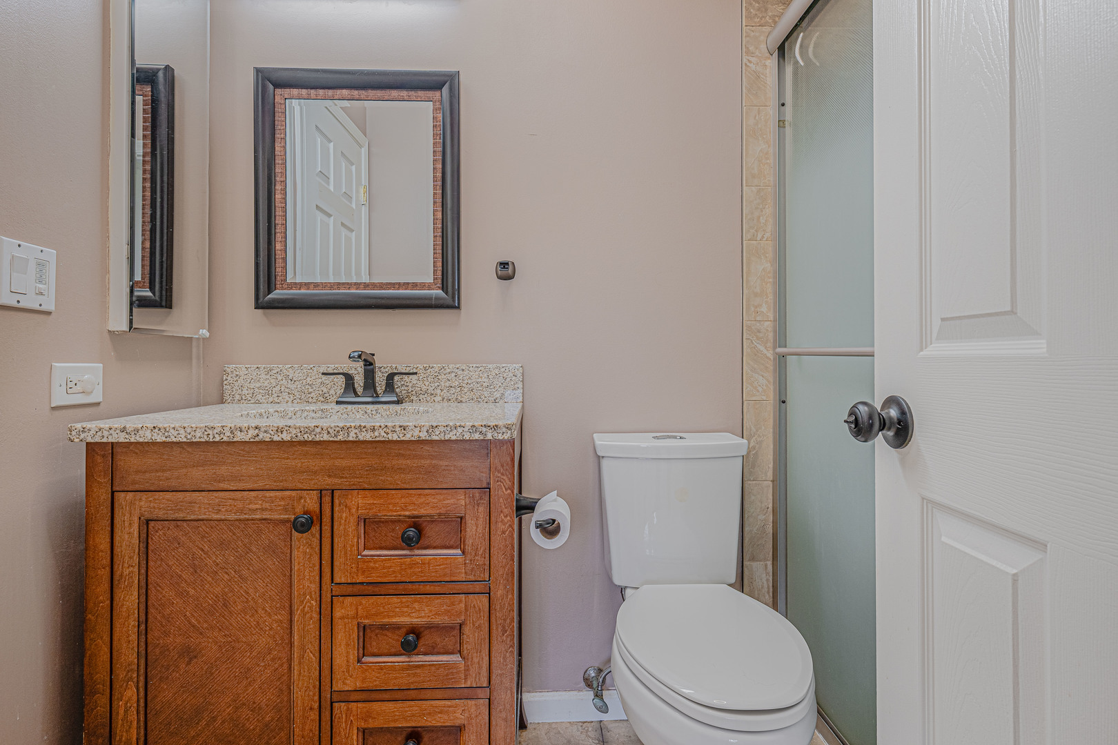 6743 Nantucket Court, Unit 6743 Gurnee, IL 60031 - Photo 20 of 30 a bathroom with a granite countertop toilet sink and mirror