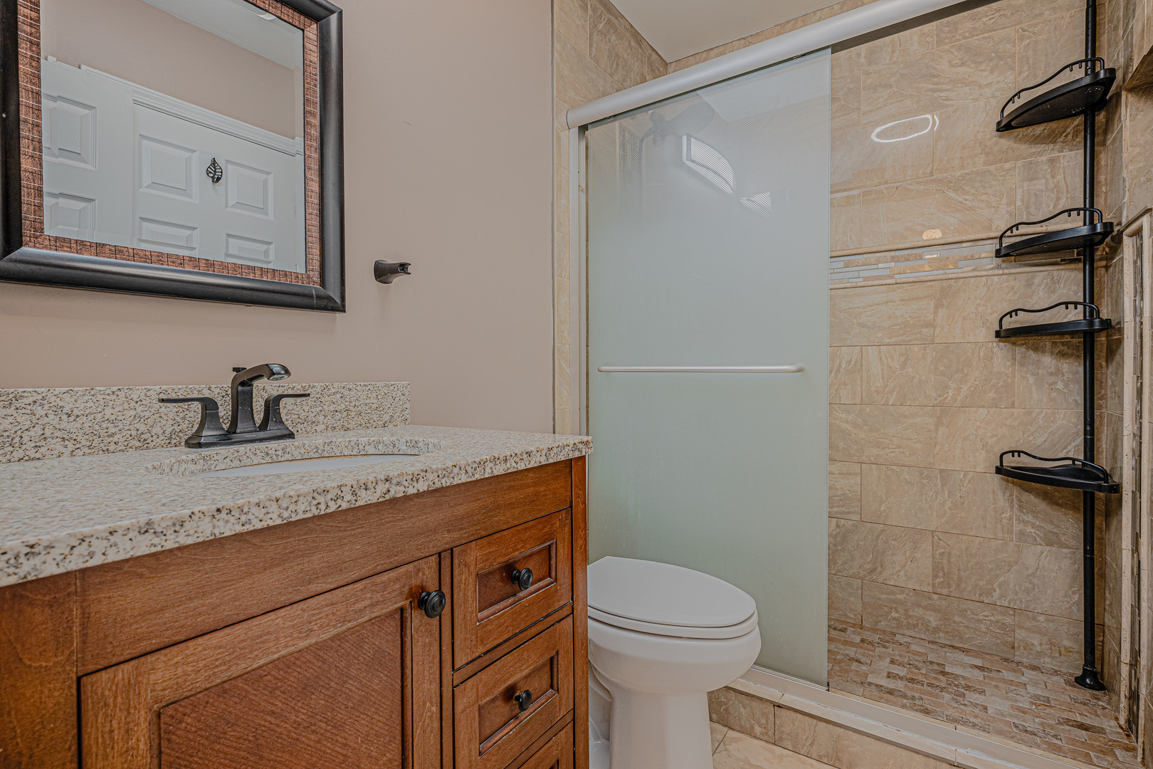 6743 Nantucket Court, Unit 6743 Gurnee, IL 60031 - Photo 21 of 30 a bathroom with a granite countertop sink toilet and a mirror