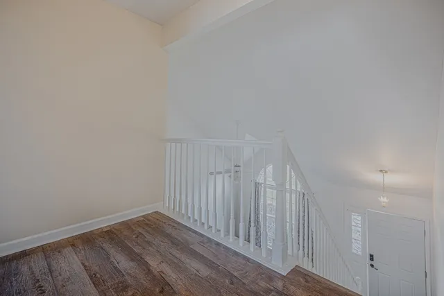 a view of a room with wooden floor