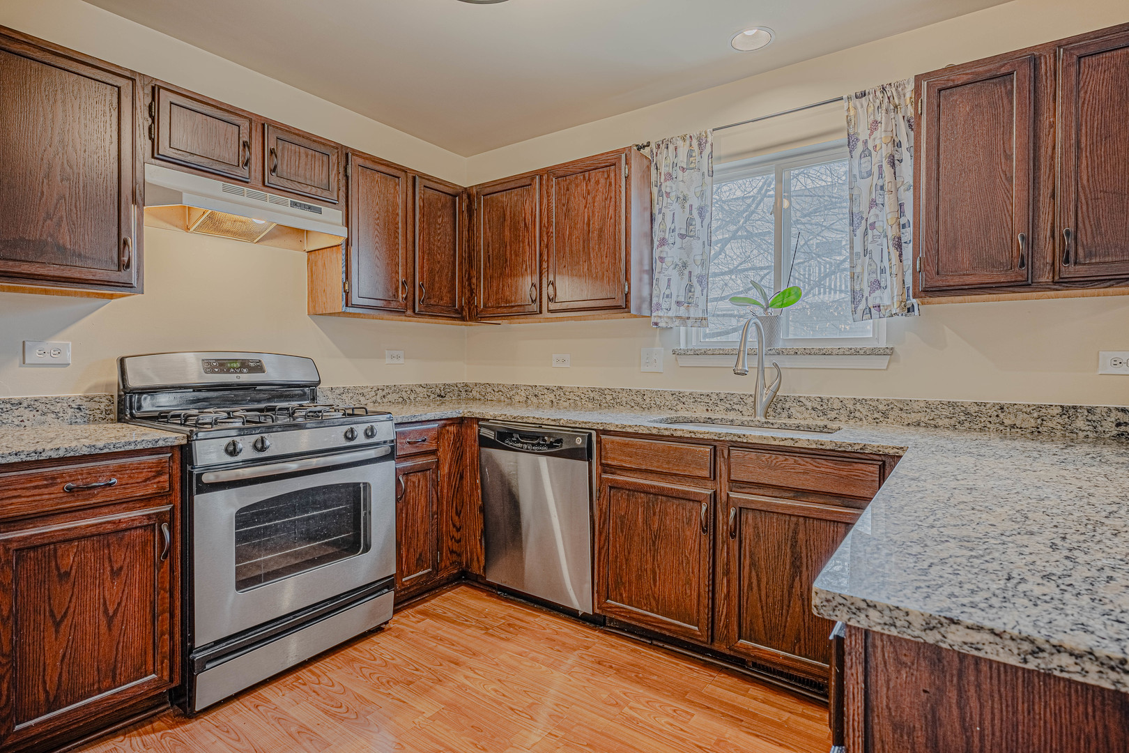 6743 Nantucket Court, Unit 6743 Gurnee, IL 60031 - Photo 8 of 30 a kitchen with granite countertop a sink stainless steel appliances and cabinets